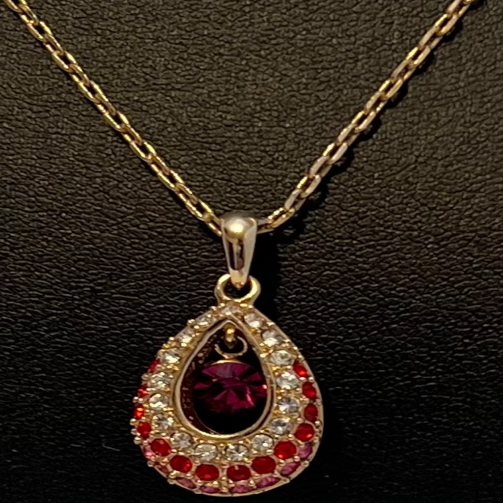Elegant Gold and Reddish-Pink Teardrop Pendant Necklace
